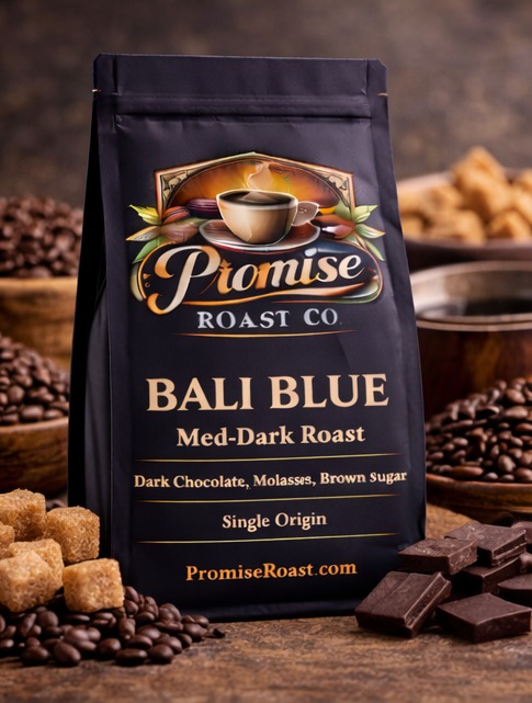 Bag of Promise Roast Co Bali Blue coffee on a wooden surface with coffee beans and chocolate.